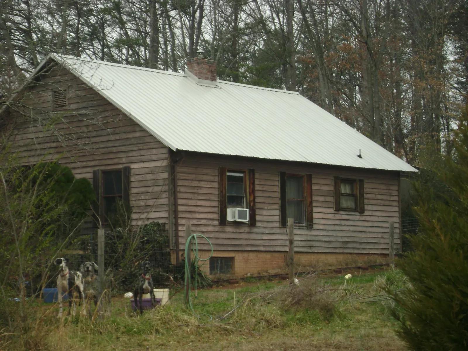 White metal roof on an old wood sided farmhouse, from a Metal Roof Installation job in Palisades